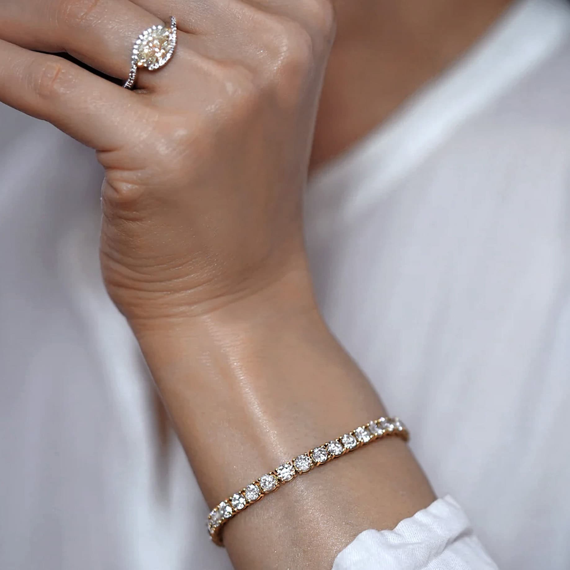 Close-up of hand wearing 18k solid gold and diamond rings by UK jewellery designer Lena Cohen