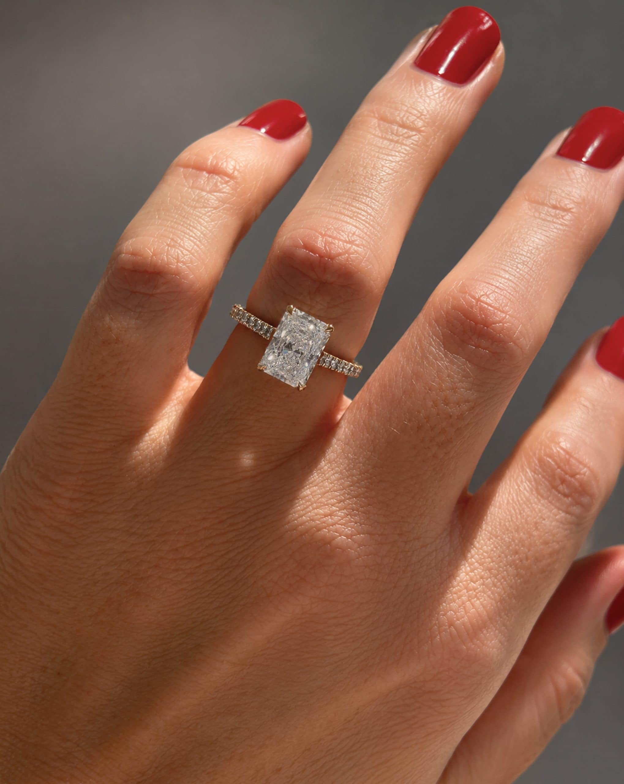adiant solitaire engagement ring with hidden diamond halo and pavé band